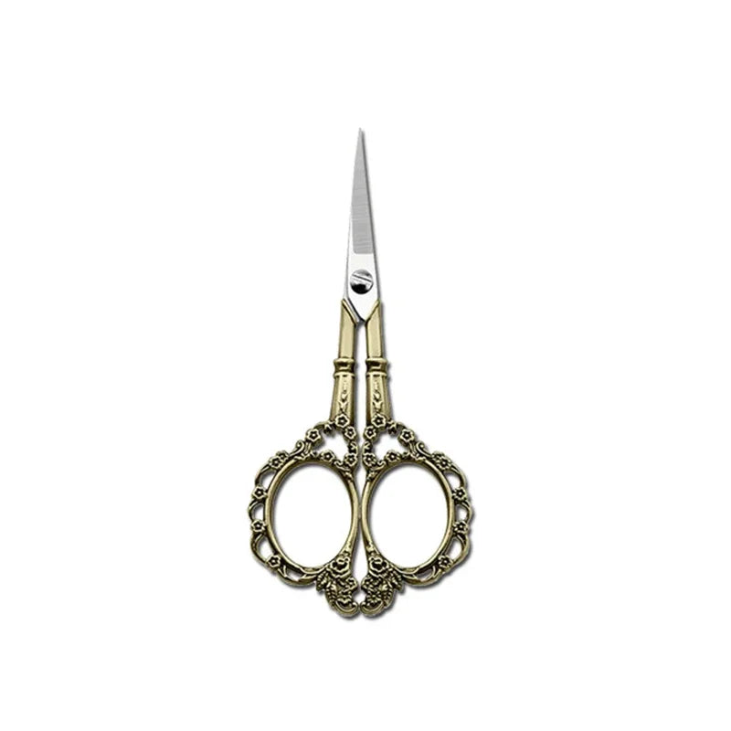 A pair of durable stainless steel crafting scissors with ornate gold-toned handles and a silver blade.