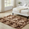 A brown shag rug is placed on a light wood floor in a bright bedroom setting.