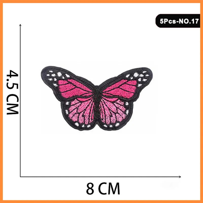 A set of five embroidered butterfly and rose iron-on patches, pink and black.