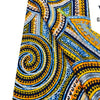 Close-up of an African wax print fabric featuring intricate blue, yellow, and black swirling patterns.