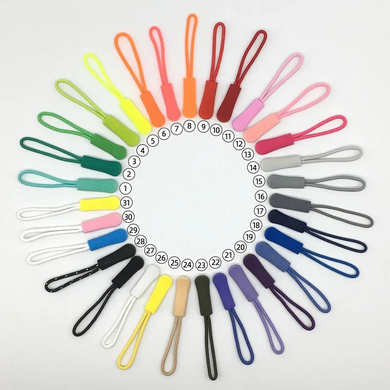 A collection of colorful replacement zipper pulls arranged in a circular pattern.