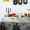 Black spider web lace table runner set for a Halloween party display