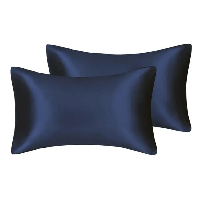 A set of dark navy blue silky satin pillow covers.