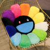 A collection of colorful, fluffy sunflower-themed plush cushions in shades of pink, orange, yellow, purple, and green are dis