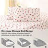 Three white pillowcases with a red heart print on a white duvet cover.
