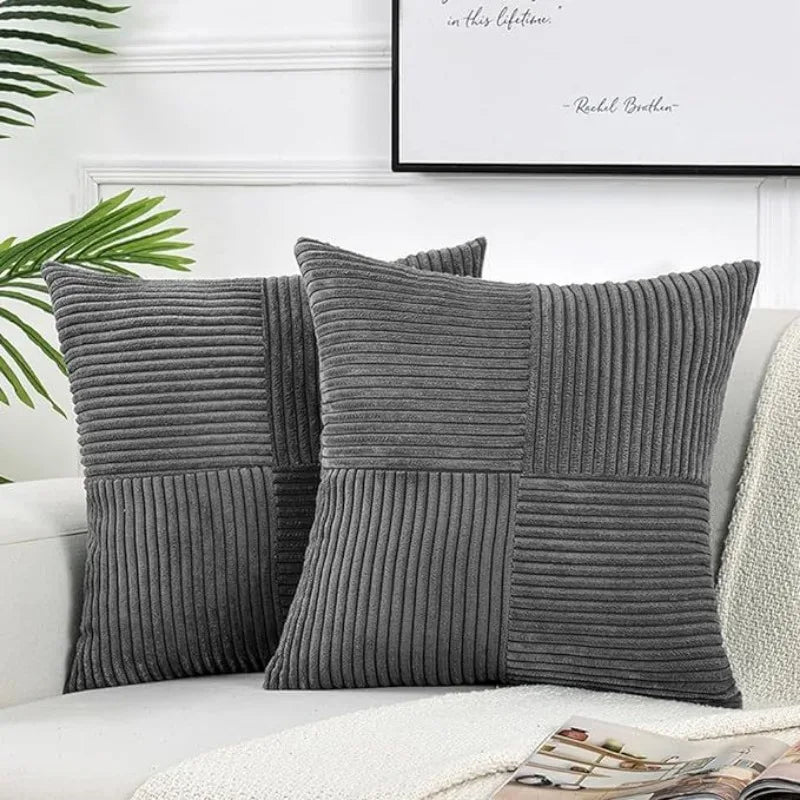 Gray corduroy patchwork pillow covers displayed on a white sofa with a framed quote in the background.