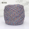 A ball of metallic silk crocheting and knitting yarn with multicolored threads.
