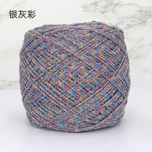 A ball of metallic silk crocheting and knitting yarn with multicolored threads.
