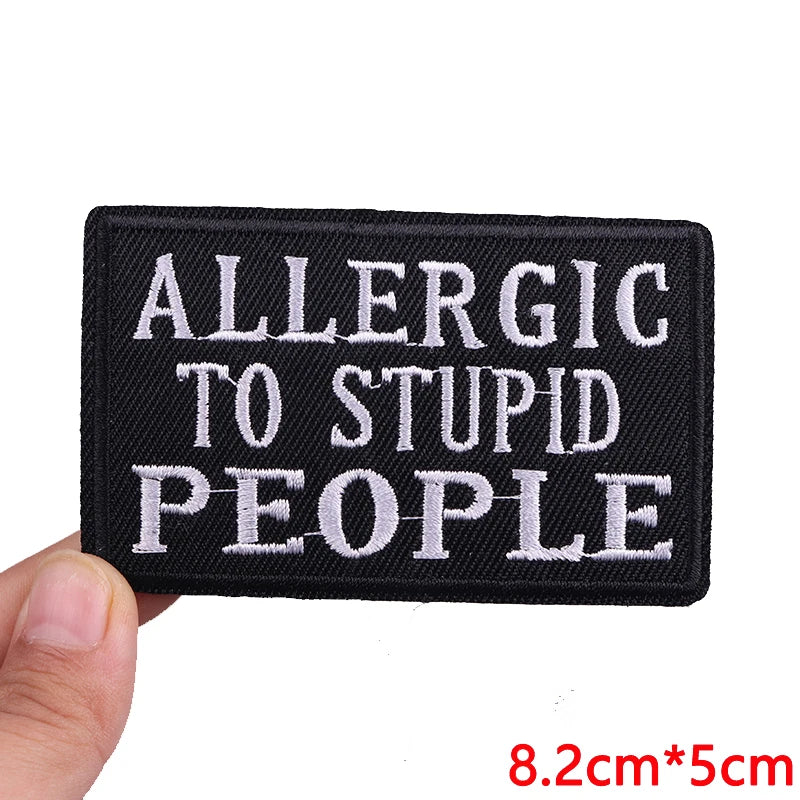 Black embroidered patch with white text that reads ALLERGIC TO STUPID PEOPLE