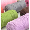 A collection of thick, colorful, twisted polyester blended yarn skeins in shades of pink, green, gray, and purple.