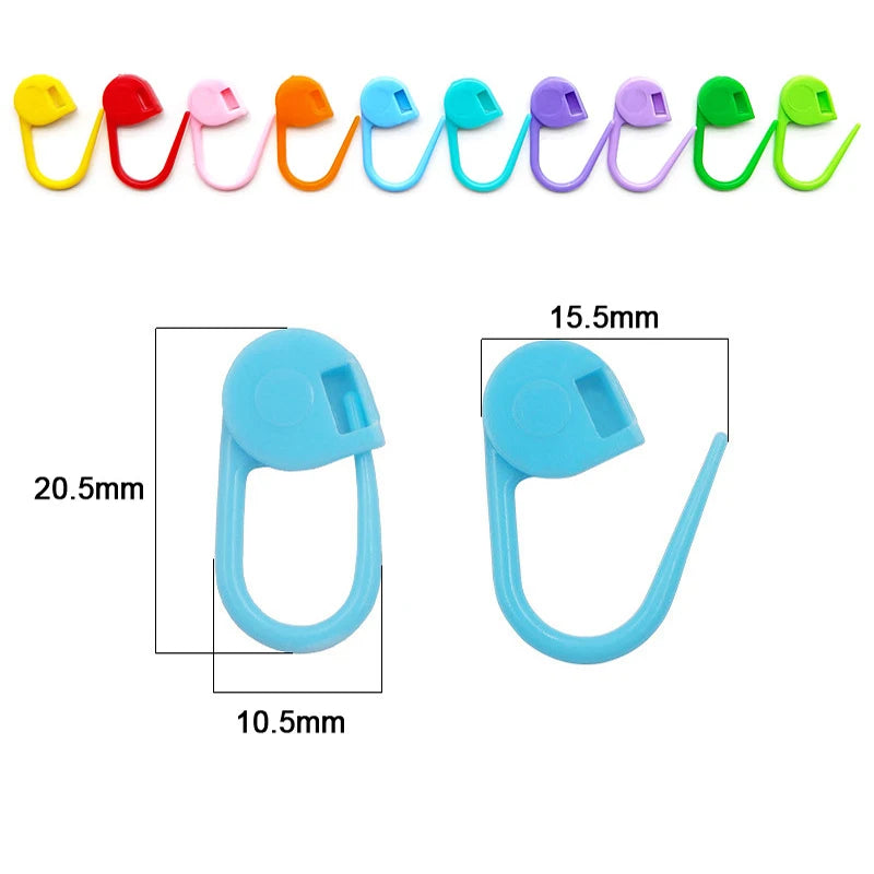 A row of colorful plastic stitch markers in various colors like yellow, red, pink, orange, blue, purple, and green.