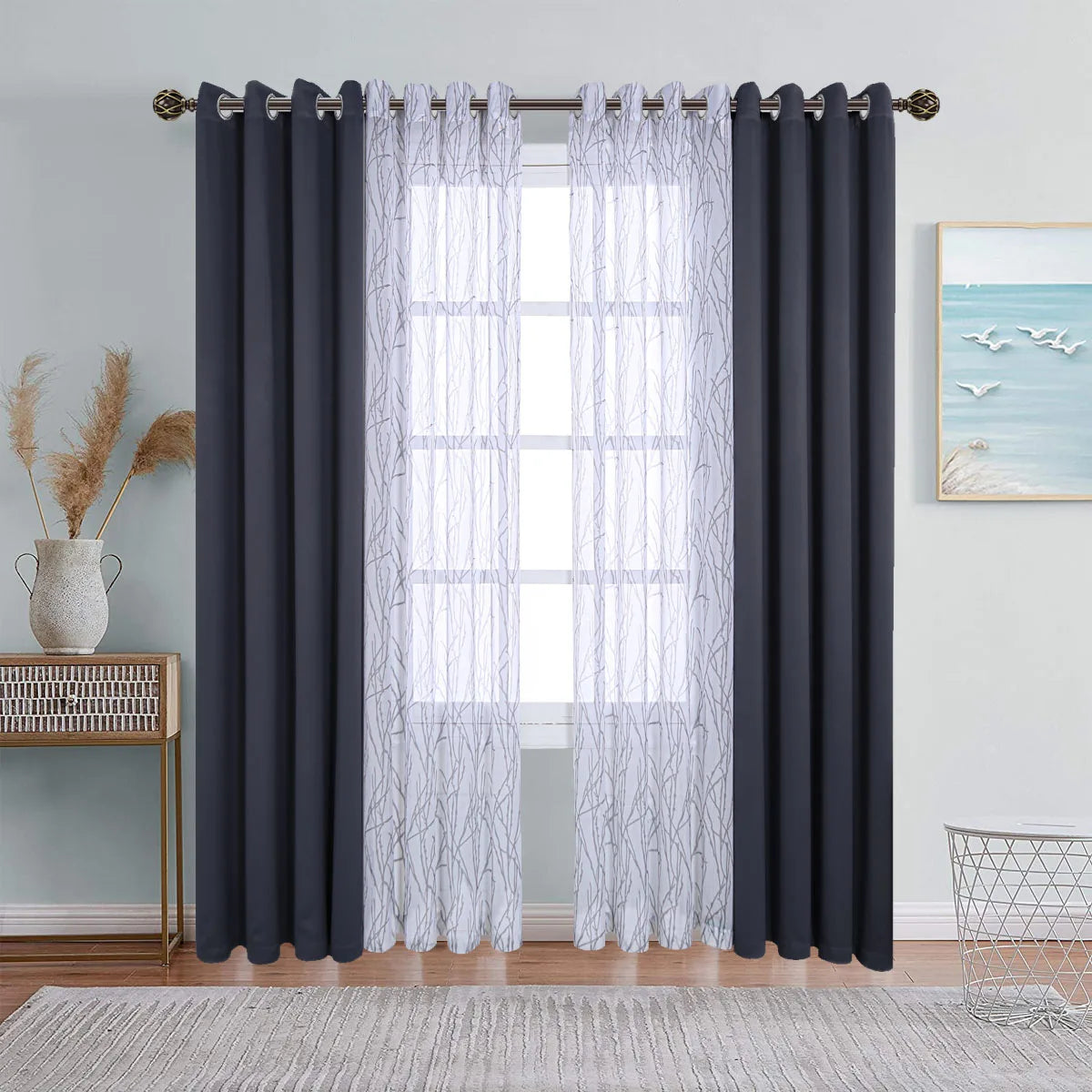 A set of gray sheer and dark blue blackout window drapes hanging on a window frame.