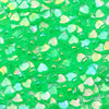A pile of bright green acrylic heart beads for jewelry making