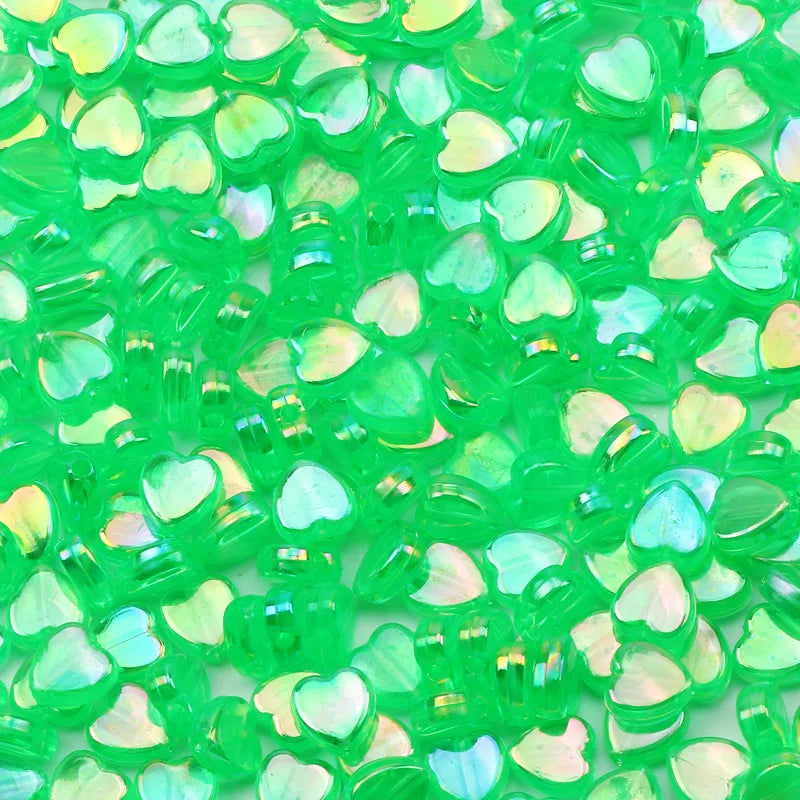 A pile of bright green acrylic heart beads for jewelry making