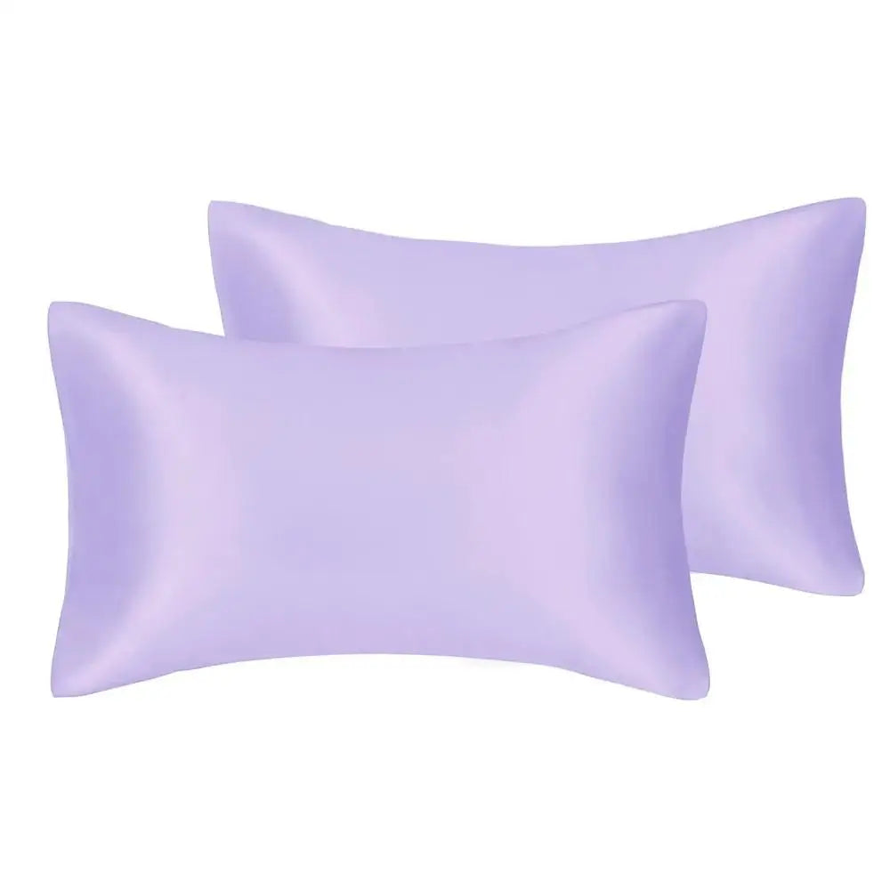 A stack of two light purple silky satin pillow covers.