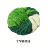 A ball of bright green and white hand-woven chunky chenille yarn.