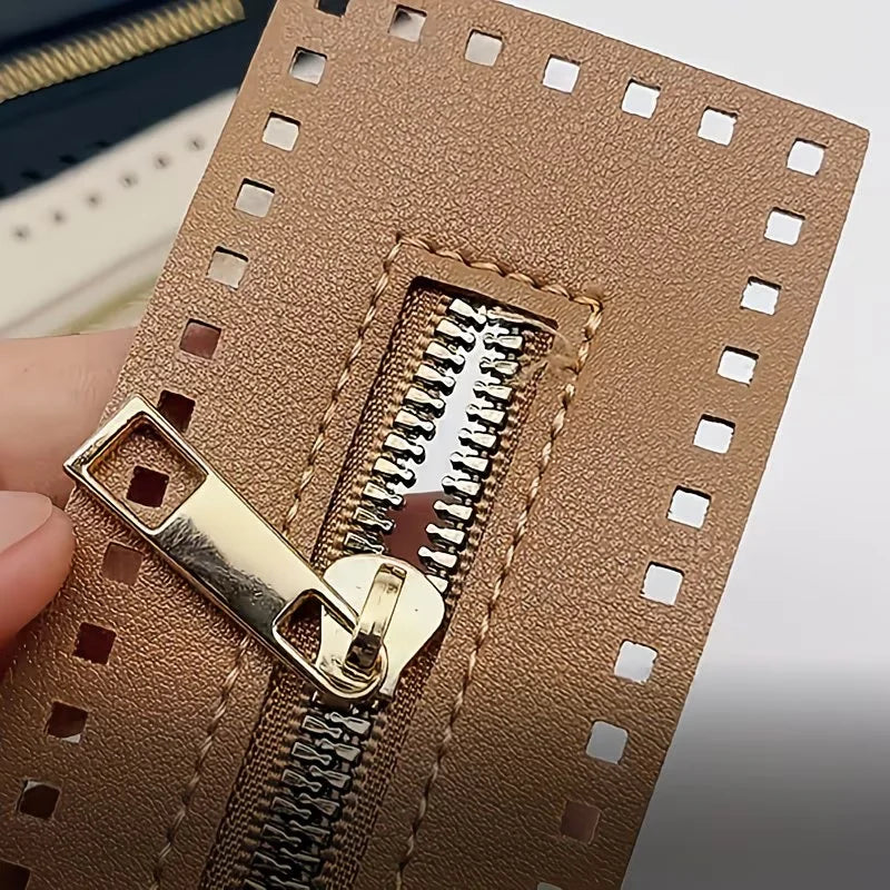 A close-up of a tan PU leather zipper frame with a gold-tone metal puller, used for handmade crochet bags.
