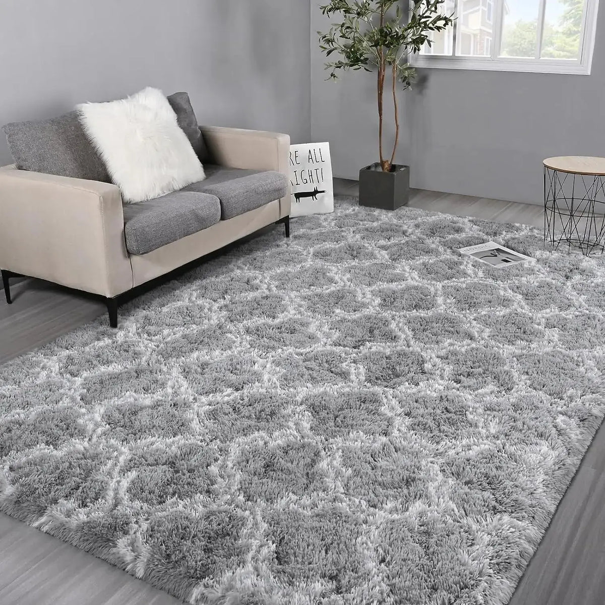 A fluffy gray geometric plush area rug placed in a modern living room setting.