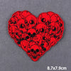 Red heart shaped embroidery patch featuring a dense pattern of skull designs