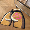 A rectangular area rug featuring a stylized paw print design in shades of gold, brown, and pink on a dark background.