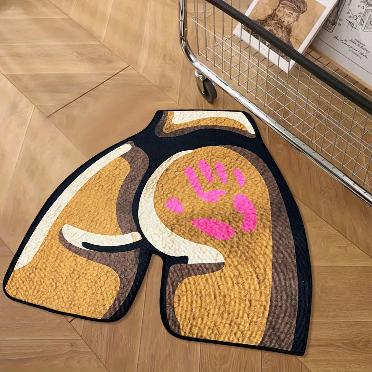 A rectangular area rug featuring a stylized paw print design in shades of gold, brown, and pink on a dark background.