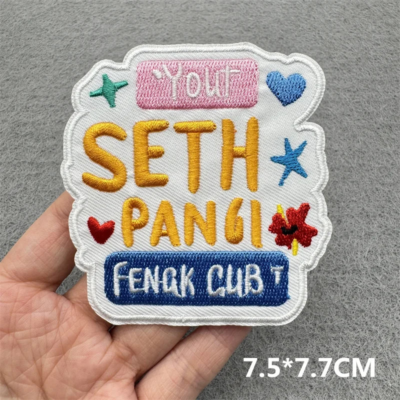 Embroidered patch featuring the text You Seth Pangsi Feng Cub in yellow and blue thread on white fabric
