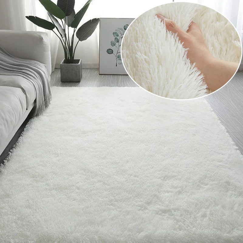 White fluffy area rug with a textured surface and a hand touching the soft fibers