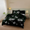 A dark green duvet cover set with a white butterfly print displayed on a bed in a bright room.