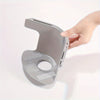 A hand is holding a gray adjustable bed sheet holder with non-slip grips against a white background.