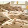 A set of beige duvet covers featuring a cute dog print pattern, displayed on a bed.