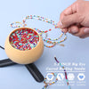 A hand holds a curved beading needle with colorful beads, demonstrating the tool for DIY jewelry making.
