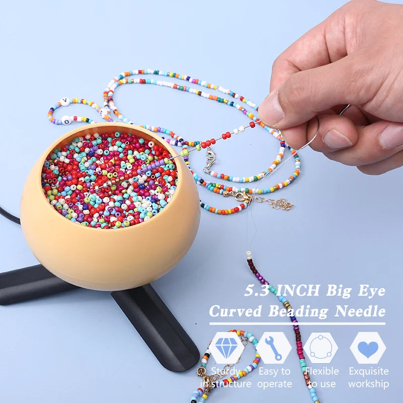 A hand holds a curved beading needle with colorful beads, demonstrating the tool for DIY jewelry making.