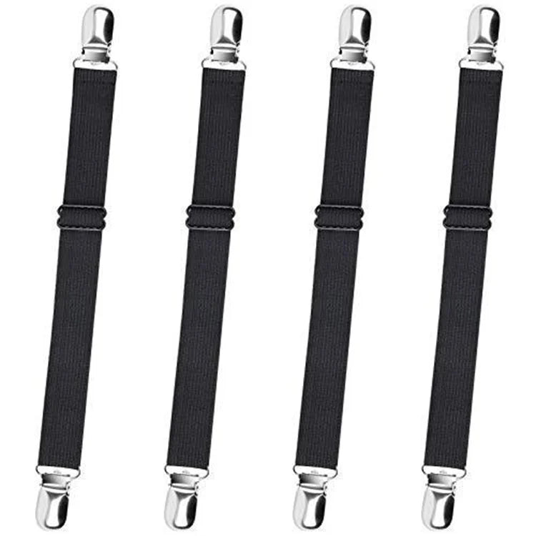 Four black adjustable bed sheet corner straps with metal hardware.