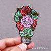 Embroidered patch featuring a bouquet of red and pink roses on a dark green background