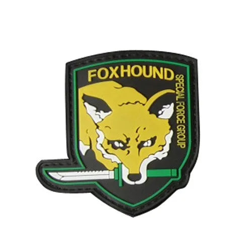 A black embroidered patch with a yellow fox head and green text reading FOXHOUND SPECIAL FORCE GROUP