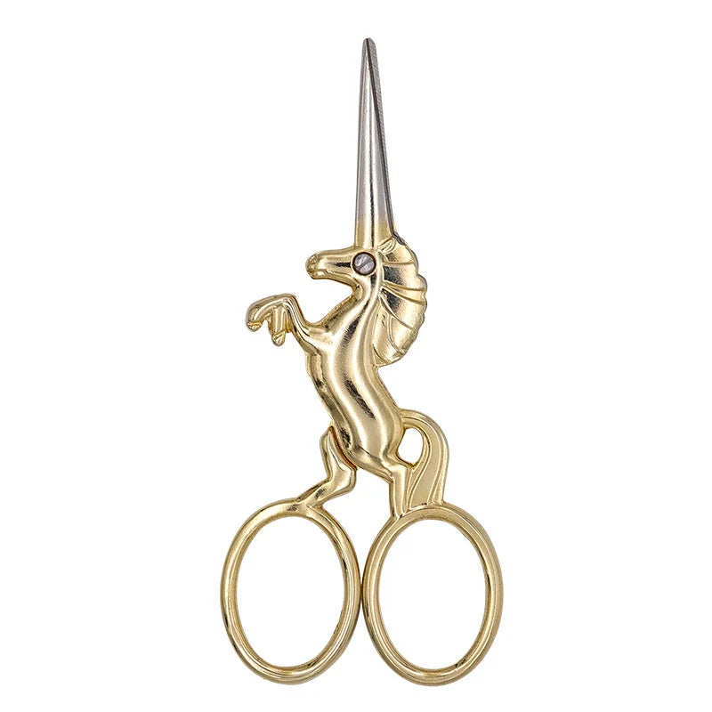 Gold stainless steel unicorn sewing scissors with a pointed tip and circular handles