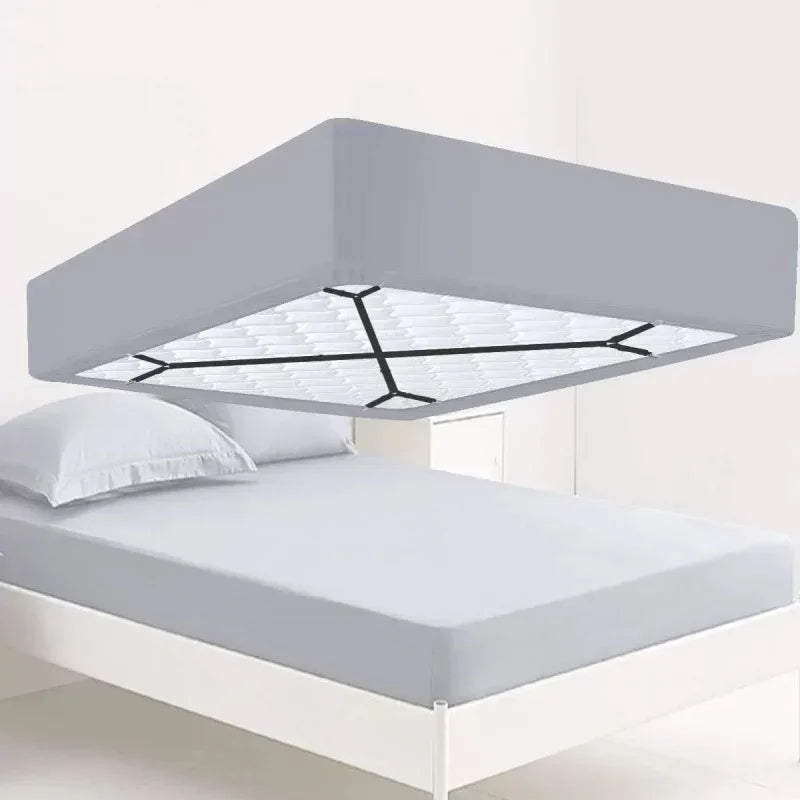 A modern gray adjustable crisscross bed sheet clip mounted above a white bed frame.