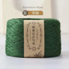 A spool of green bamboo fiber yarn labeled as 11 strands for crafting.