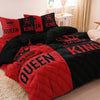 A couple duvet set featuring a pink and black crown print microfiber bedding on a bed.