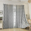 Gray tree bark pattern blackout curtains hanging in a light-colored room.