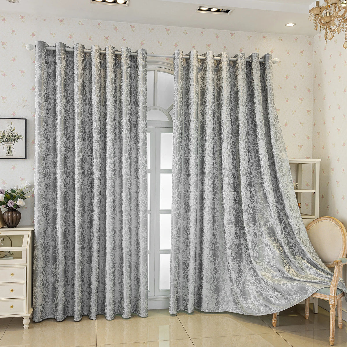 Gray tree bark pattern blackout curtains hanging in a light-colored room.