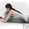 A woman is lying down using an ergonomic memory foam wedge pillow for neck, back, and leg support.
