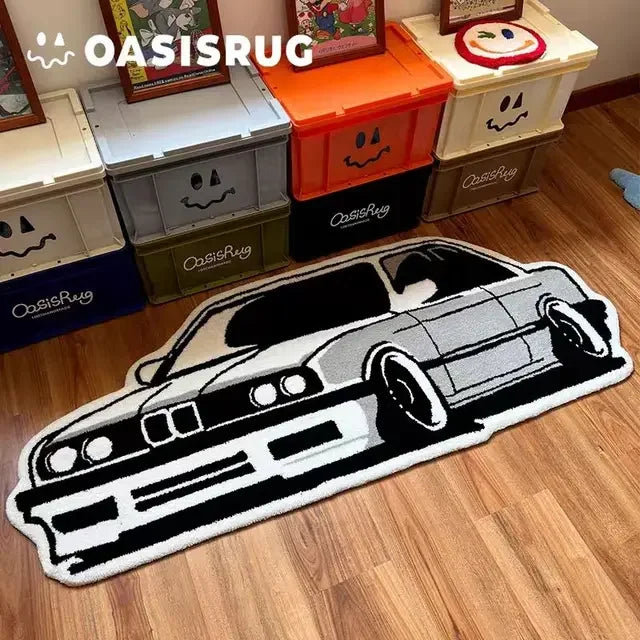A black and white patterned car carpet is displayed in front of storage boxes labeled OasisRug.