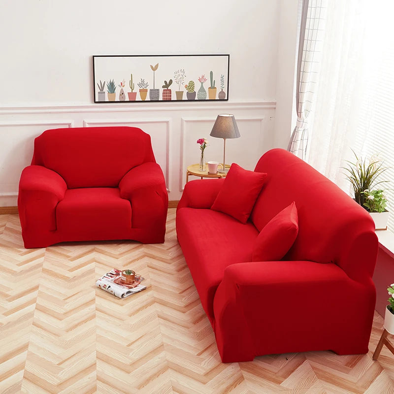 A vibrant red faux silk sofa cover is displayed in a bright room with a wooden floor and framed art.
