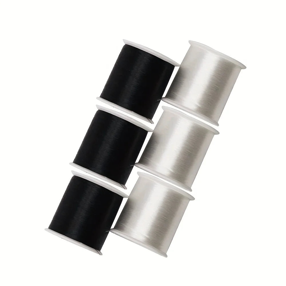 Rolls of black and silver invisible nylon sewing thread stacked diagonally