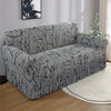 A gray pleated fabric sofa cover displayed on a light-colored floor.