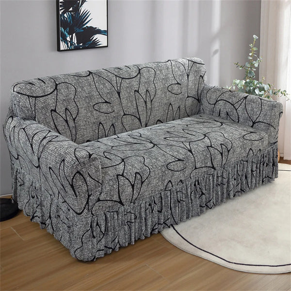 A gray pleated fabric sofa cover displayed on a light-colored floor.