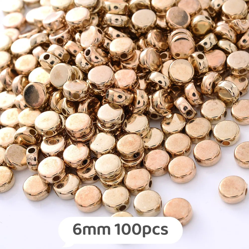 A pile of gold-colored geometric acrylic beads for jewelry making