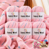 A set of pink gradient alpaca wool yarn skeins for knitting and crochet projects.