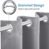 Close-up of a grey blackout curtain with a grommet design attached to a metal rod.